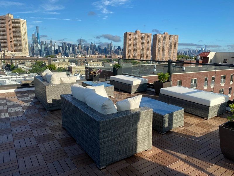 A rooftop patio with a view of the city skyline
