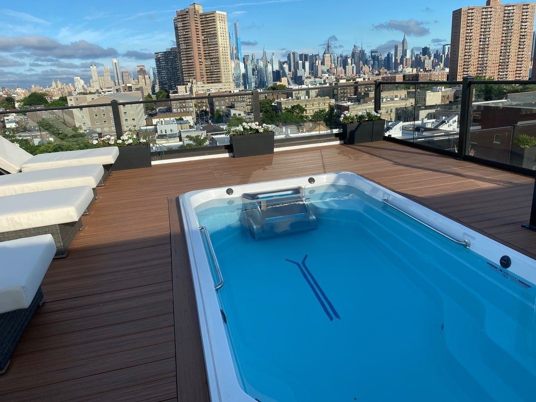 A swimming pool on a rooftop with a view of the city
