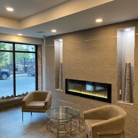 A living room with two chairs and a fireplace