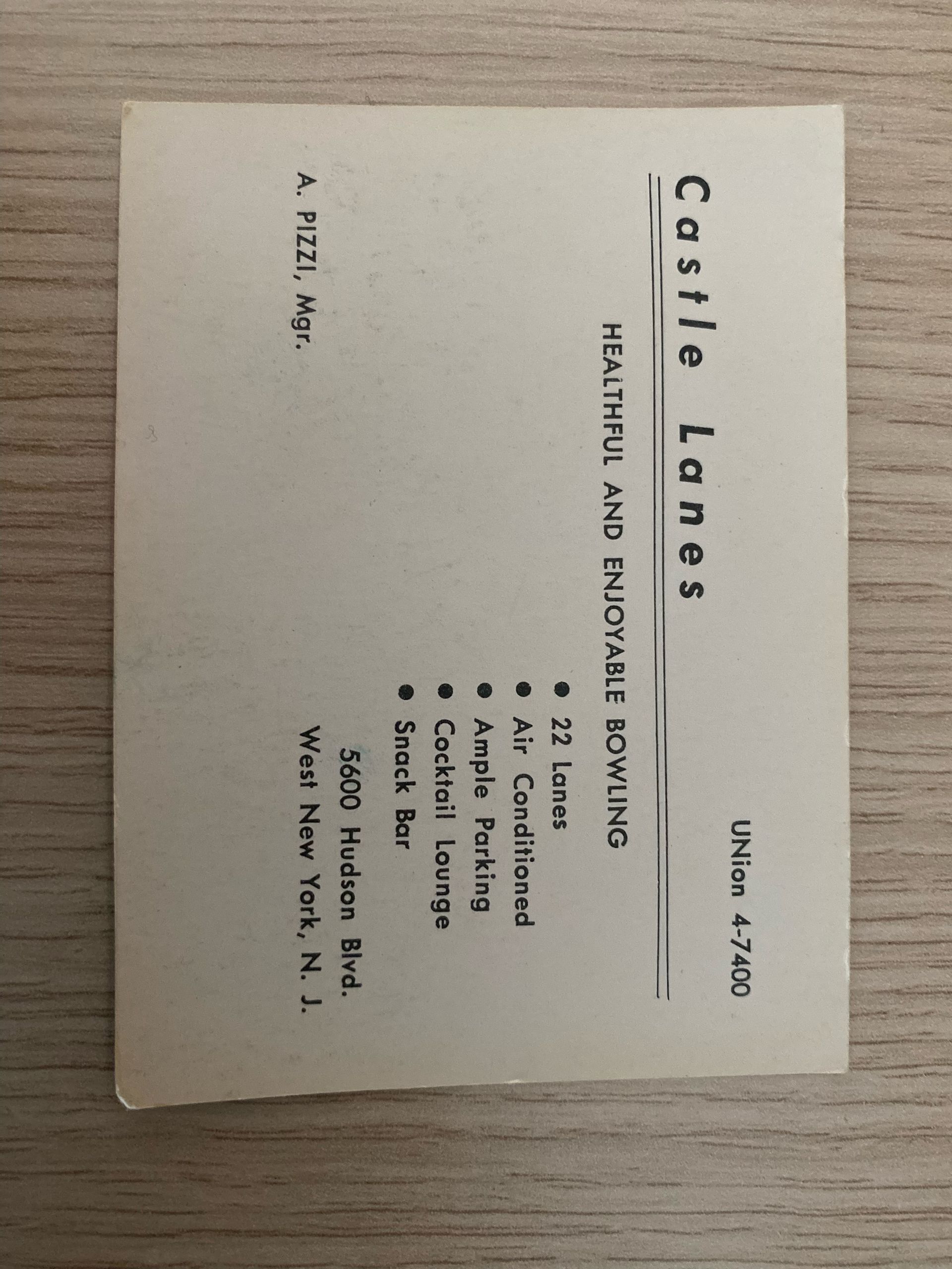 A business card for the castle lanes bowling alley