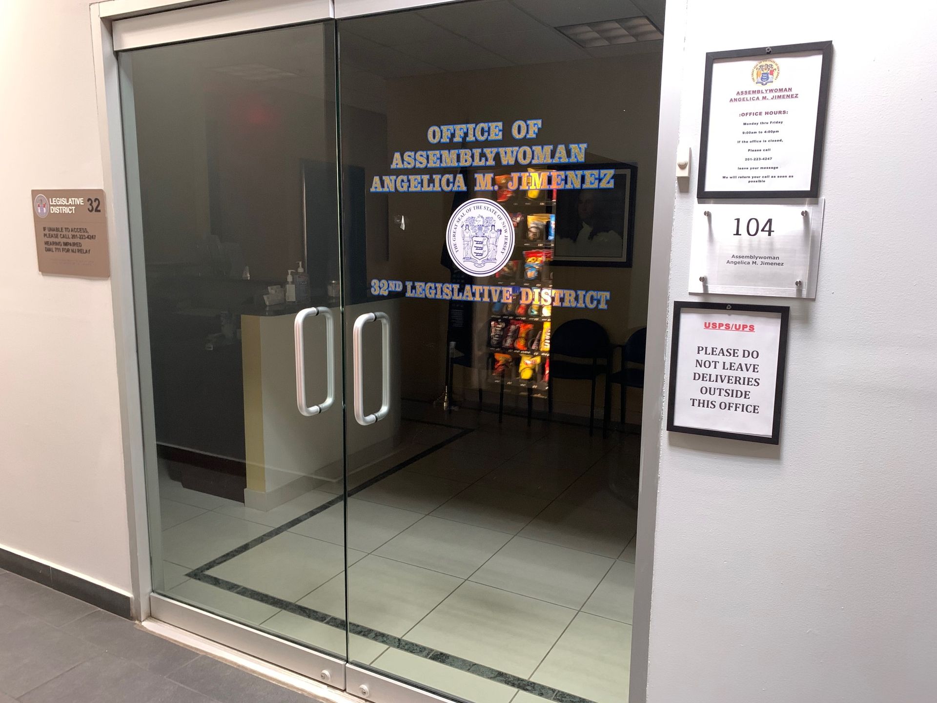 A glass door with a sign on it that says office of assemblywoman