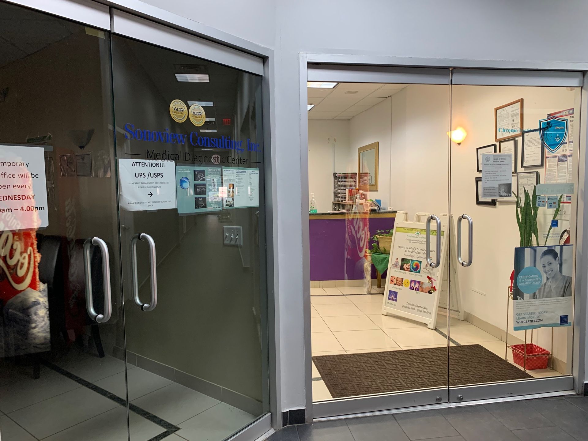 A store front with a glass door and a purple counter.