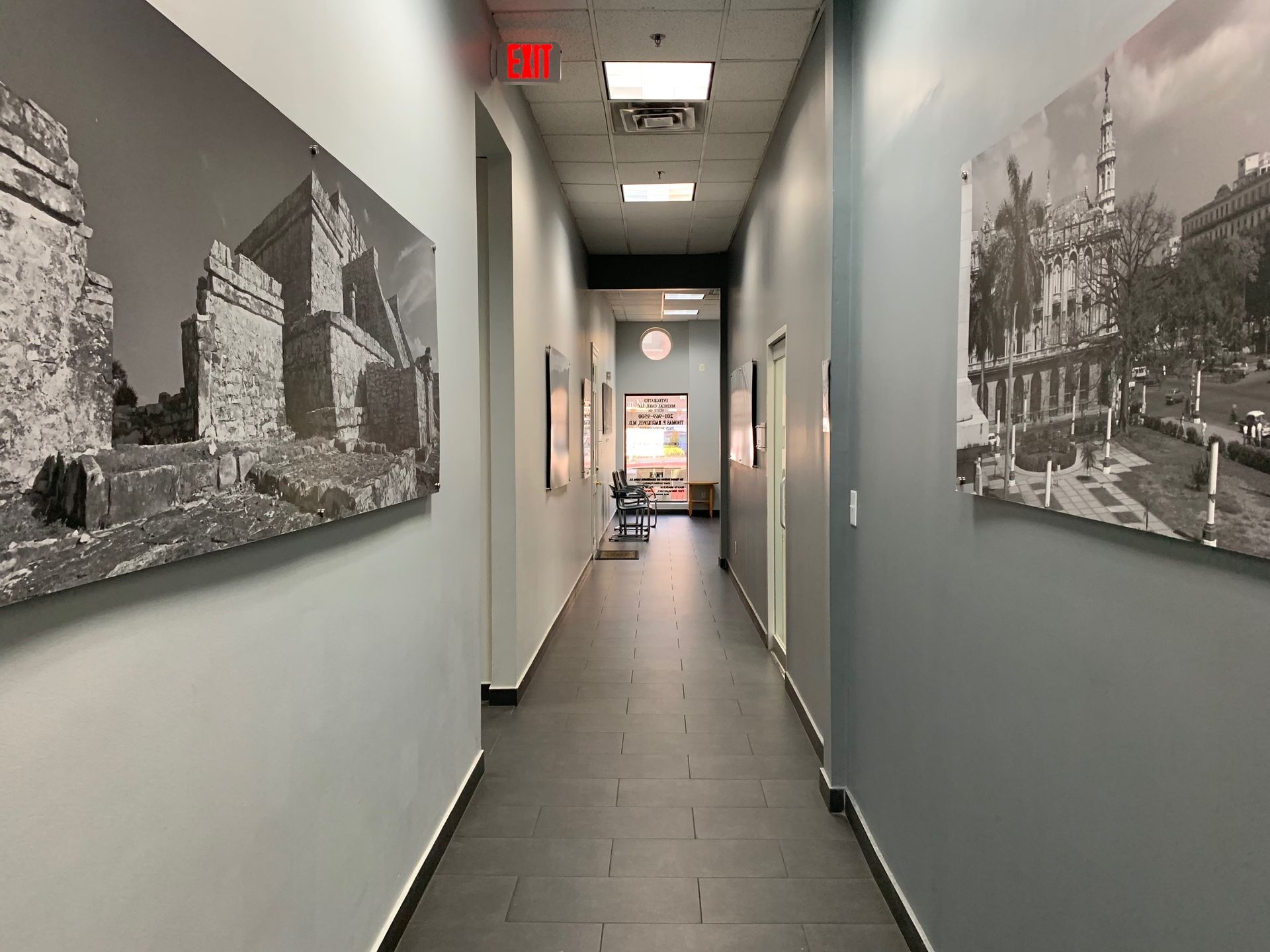 A long hallway with a lot of pictures on the wall.