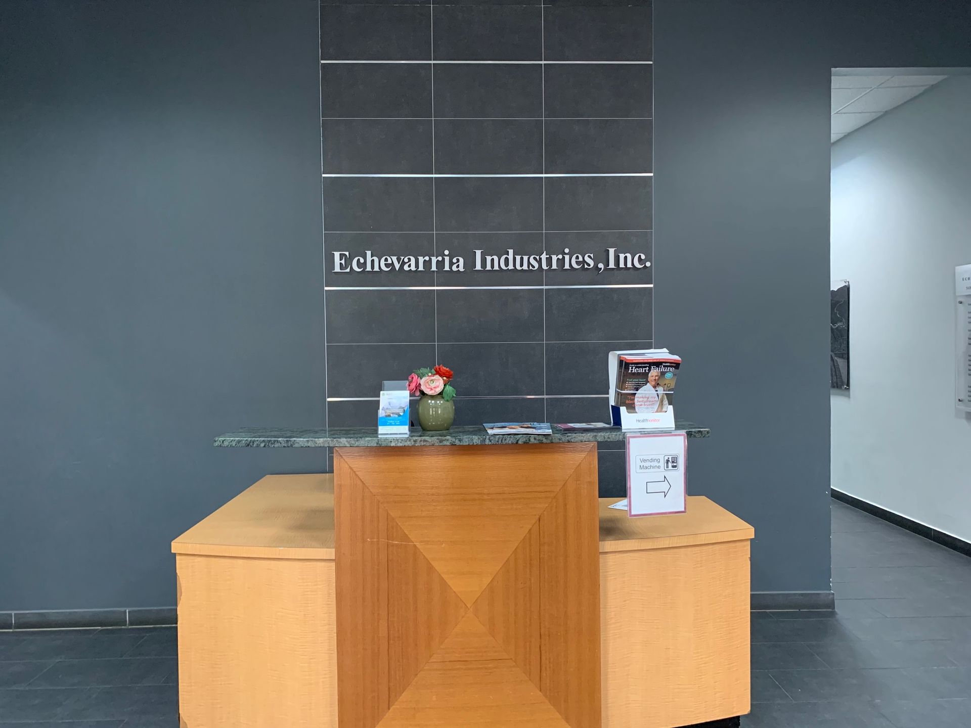 A wooden desk in front of a wall that says evergreen industries inc.