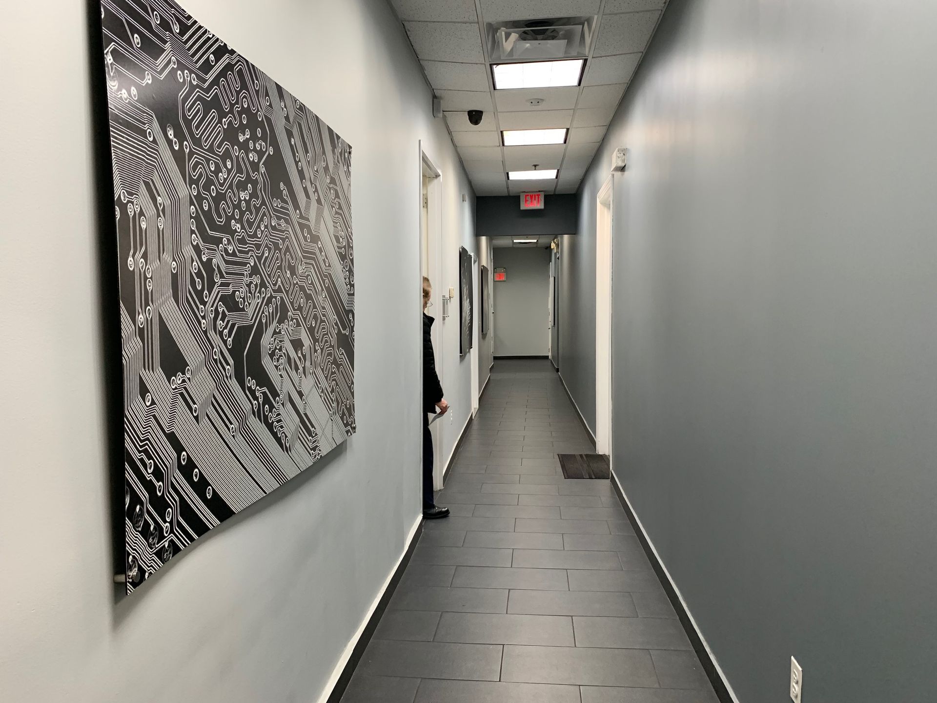 A long hallway with a painting on the wall