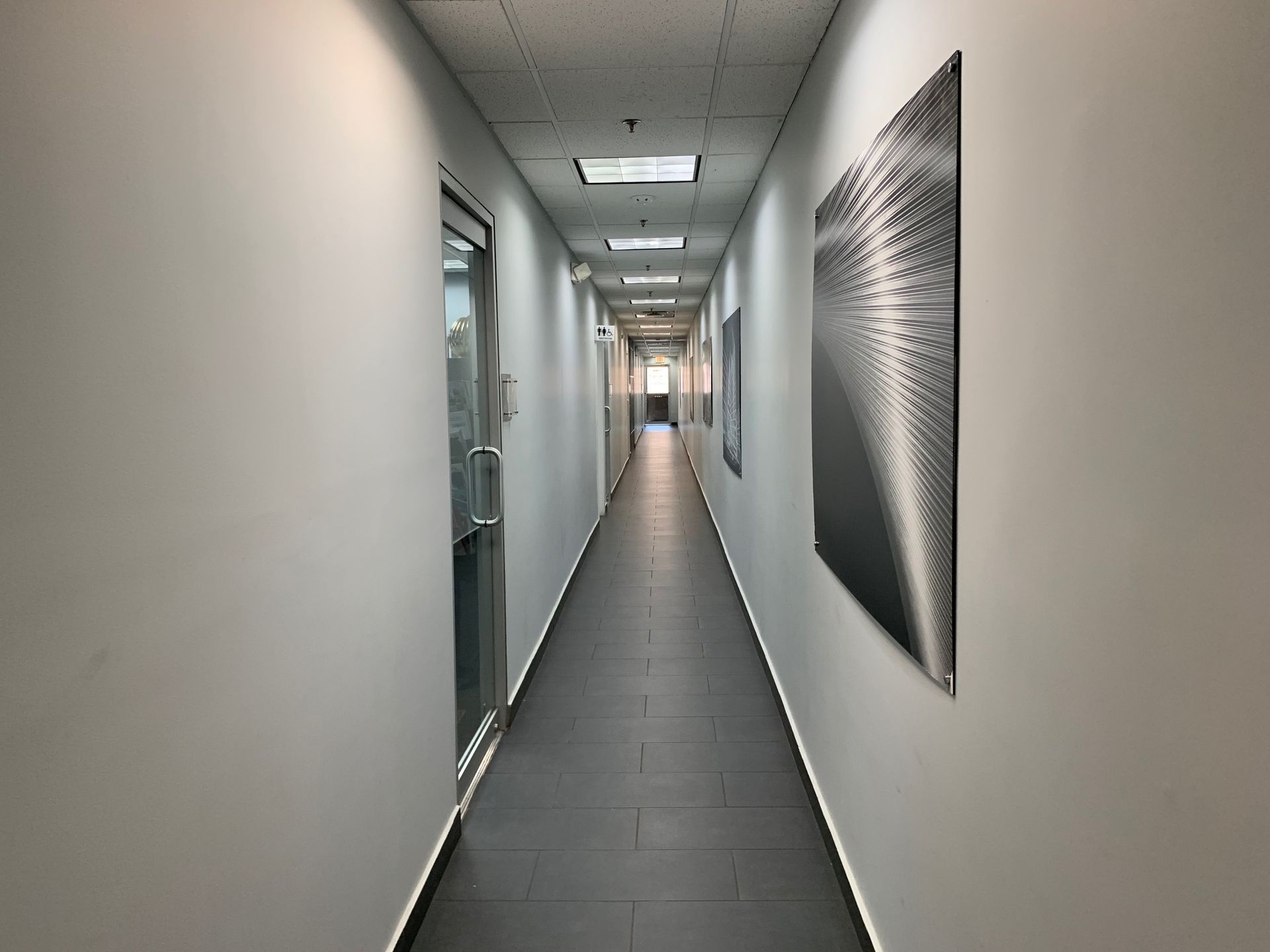 A long hallway with a picture on the wall