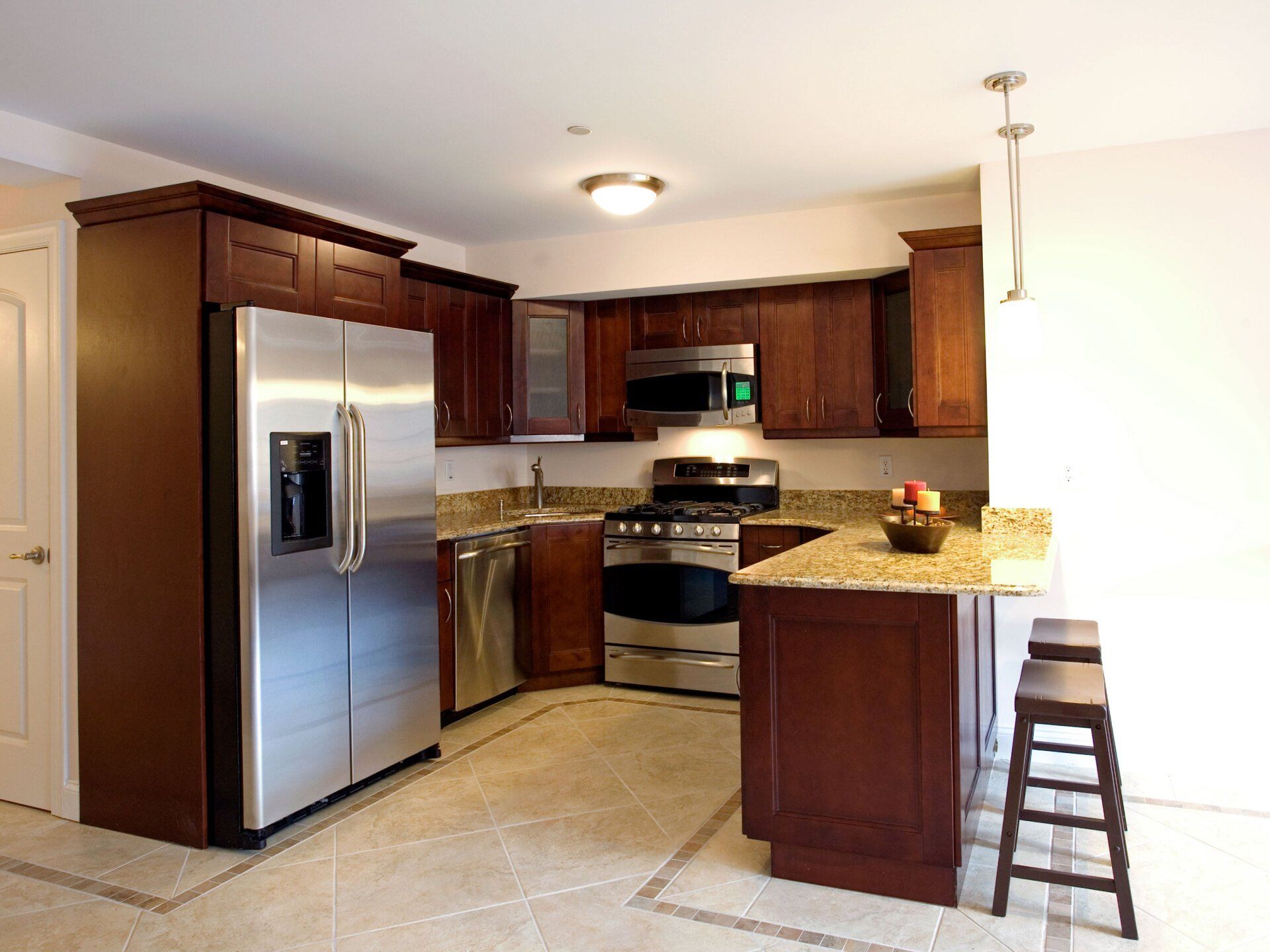 A kitchen with stainless steel appliances and wooden cabinets