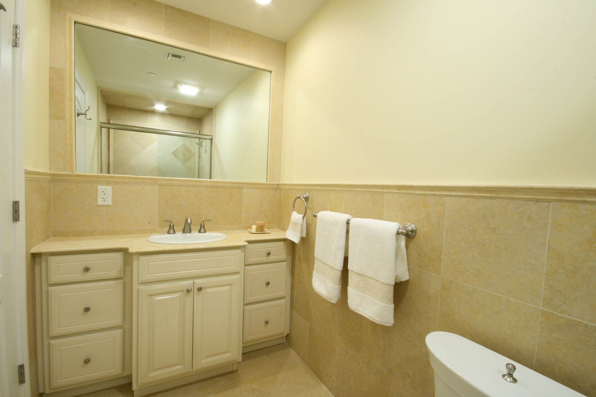 A bathroom with a sink , toilet and mirror