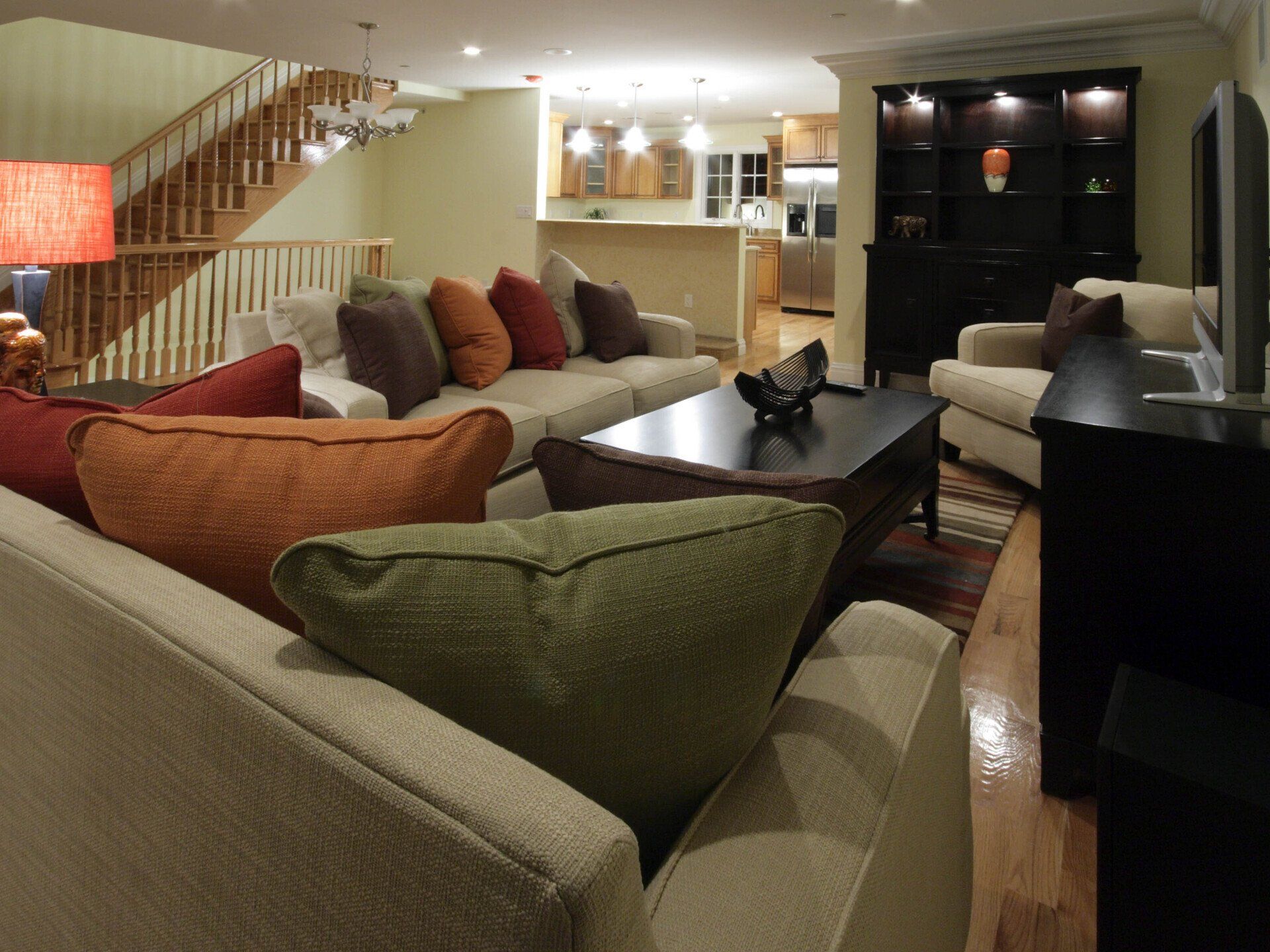 A living room filled with furniture and a staircase in the background