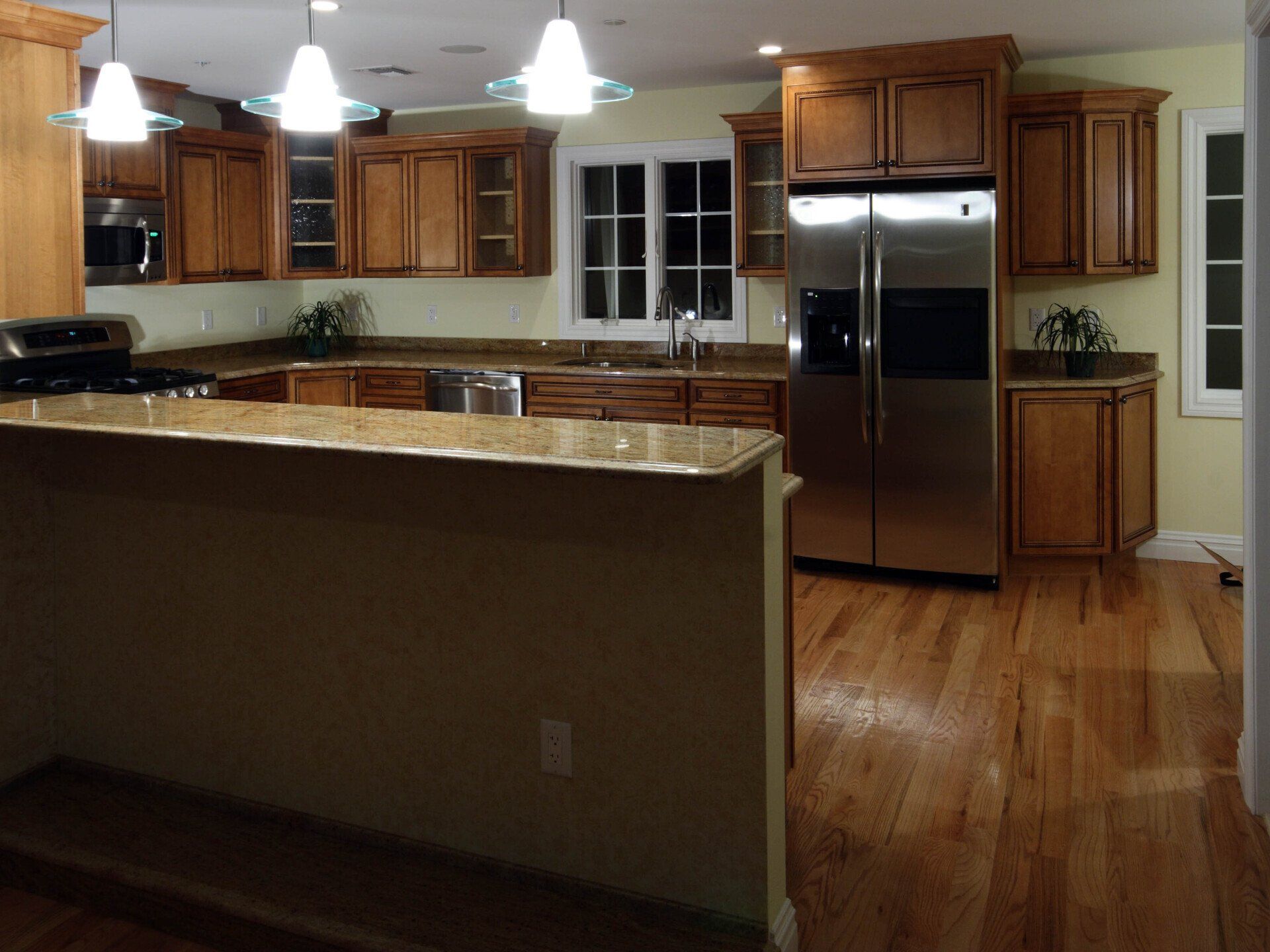 A kitchen with stainless steel appliances and wooden cabinets