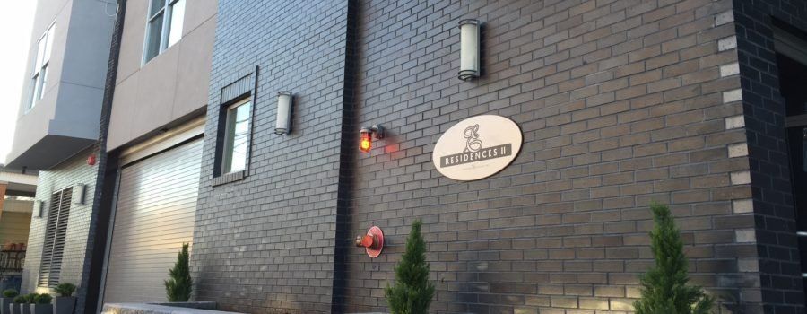 A large brick building with a sign on the side of it.