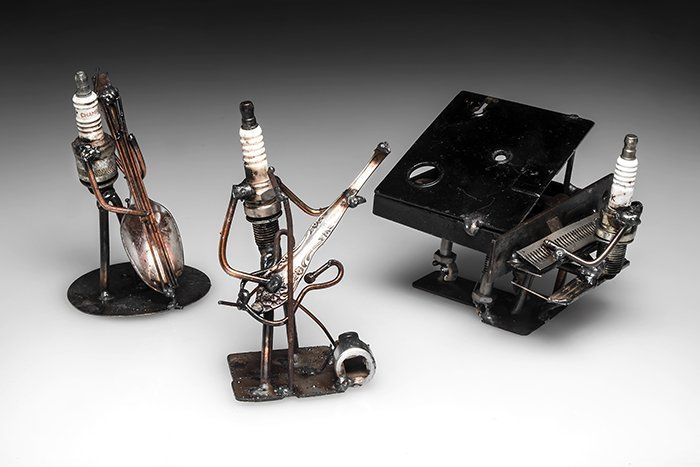 Upcycled Sparkplug Sculpture of 3 Figures playing musical instruments