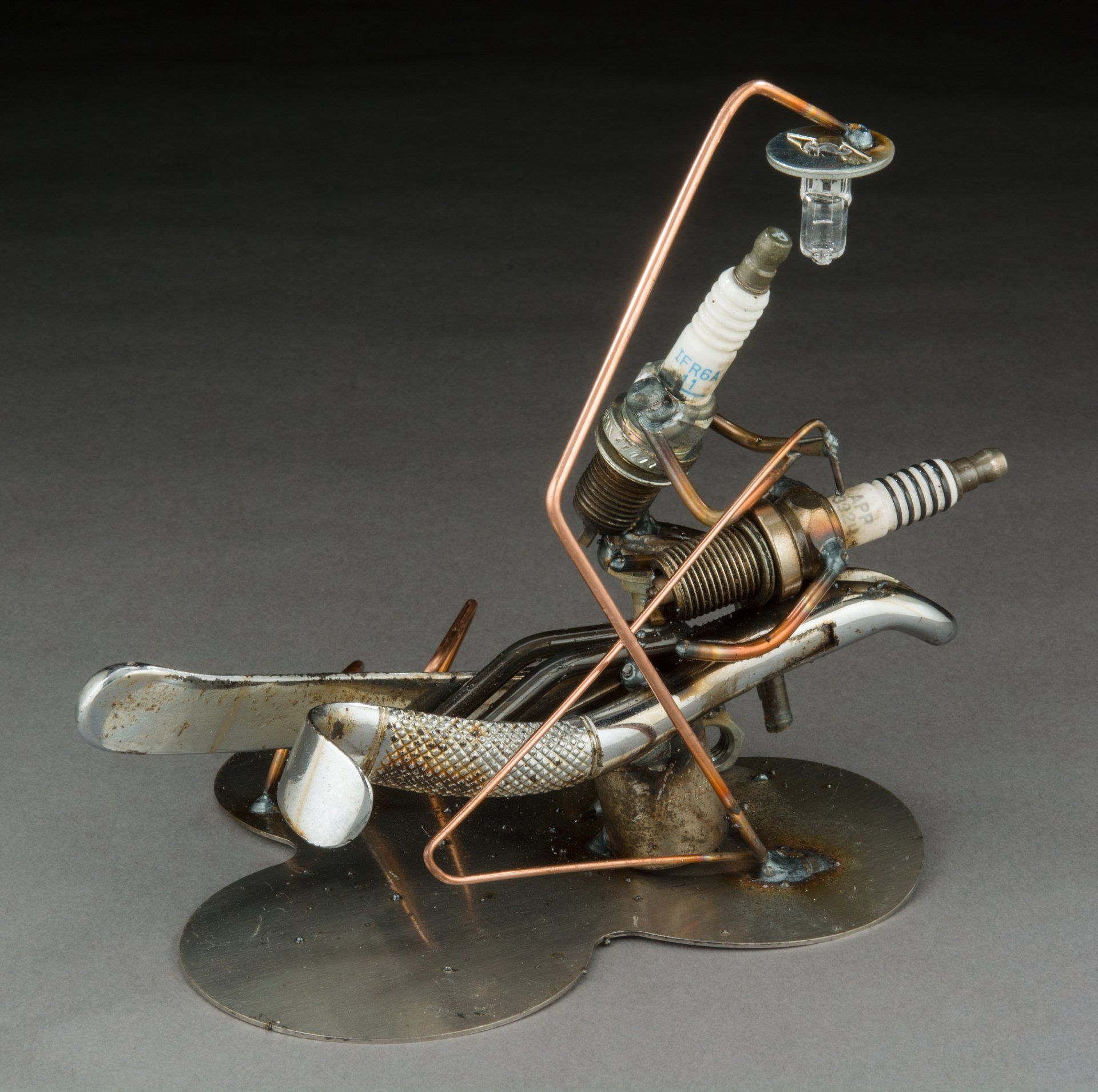 Sparkplug Sculpture of Dentist working on Patient in Chair