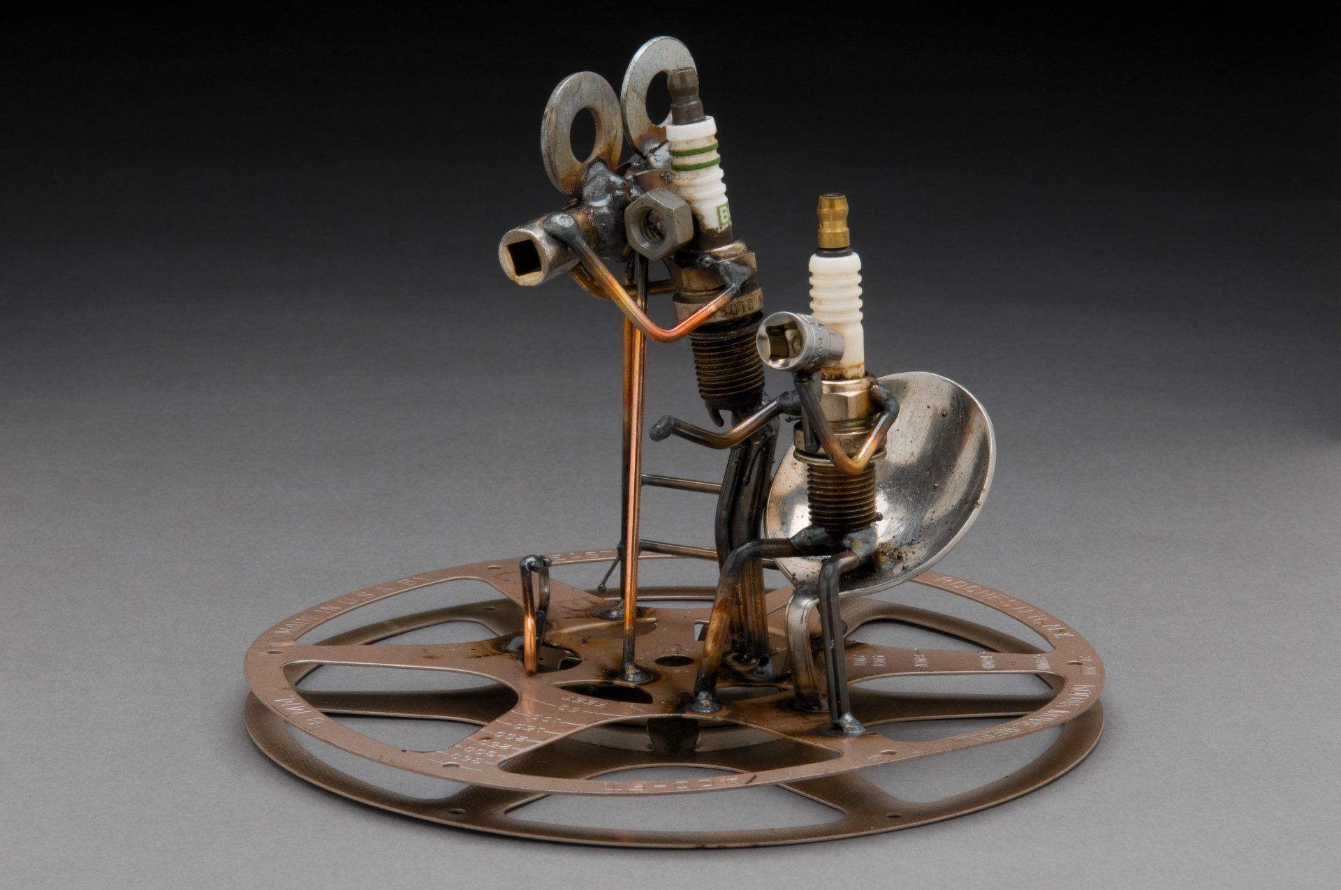 Sparkplug Sculpture of Creative Director and Camera Man