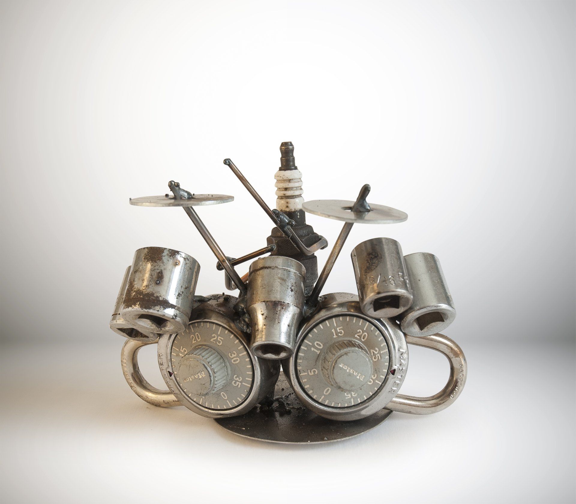 Sparkplug Sculpture - Figure playing drums