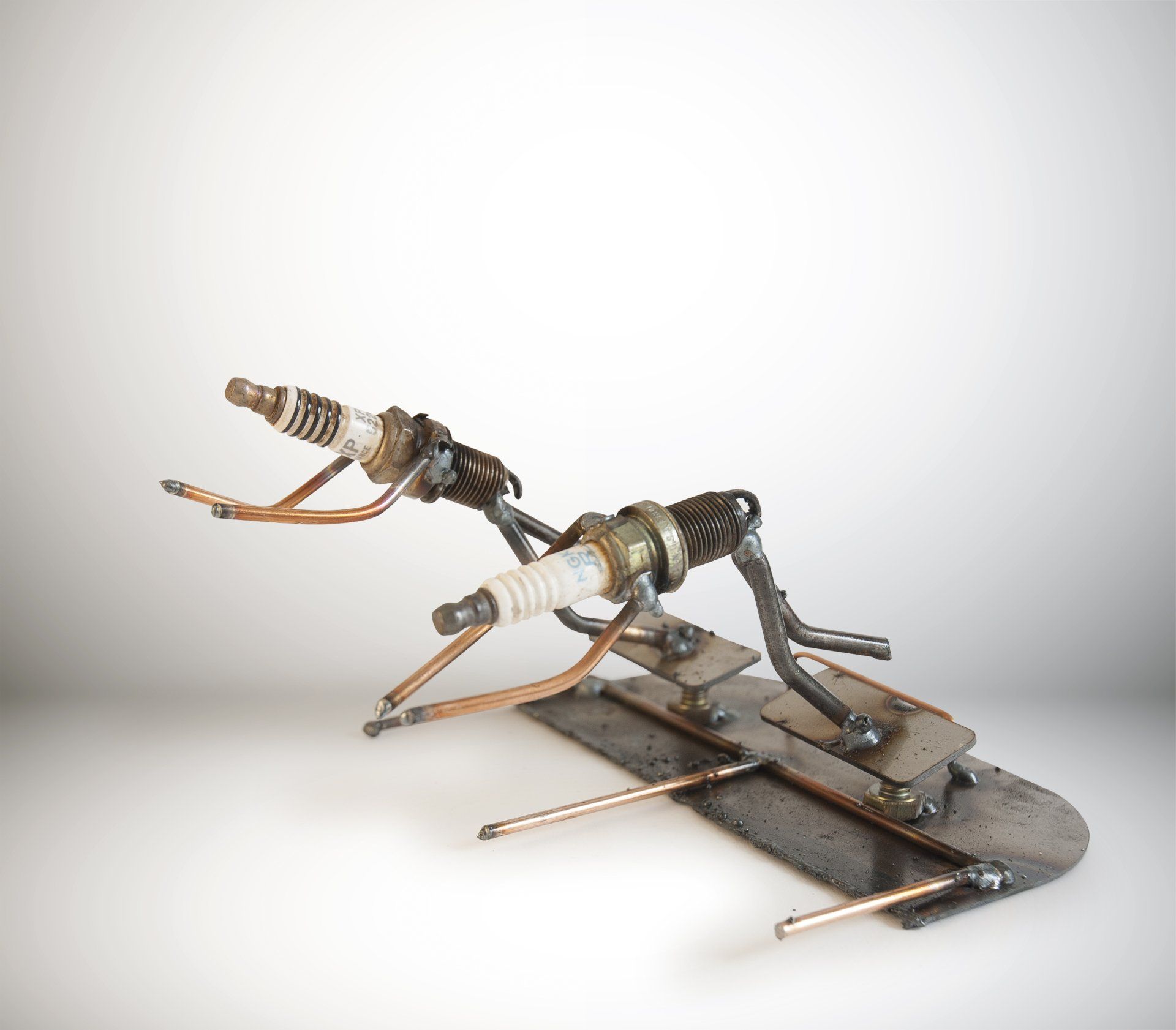 Sparkplug Sculpture of 2 Swimmer Figurines diving into water