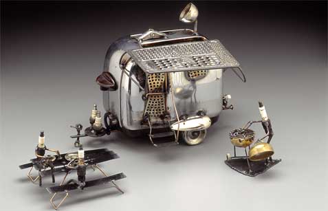 Vintage toaster with metal roller skate wheels and a cheese grater awning with satellite dish with Weber grill and picnic table - one of my favorites! Camper varies in price. Camper alone $90; with bicycles or Harley on back, add $40