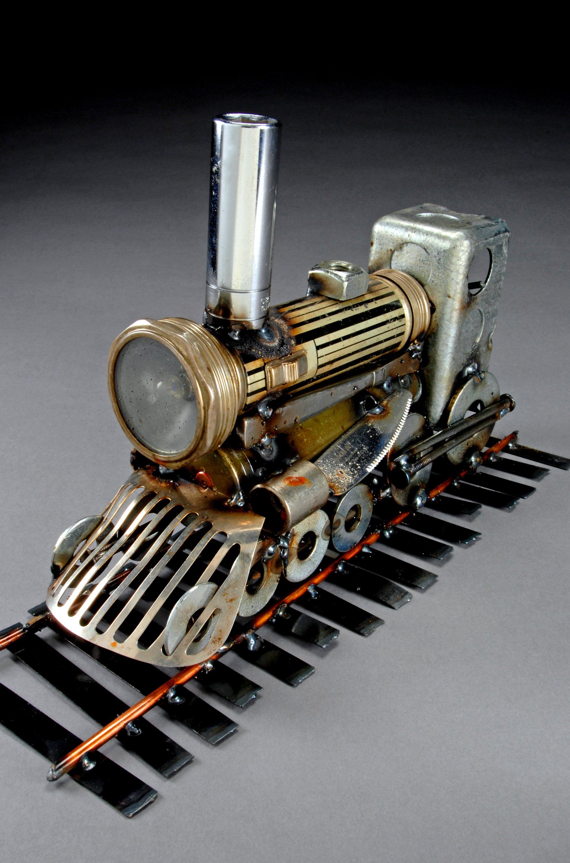 Sparkplug Sculpture of Train on Track