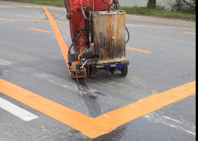 someone doing asphalt markings