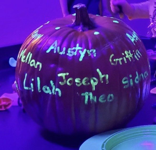 A pumpkin with glow in the dark writing on it