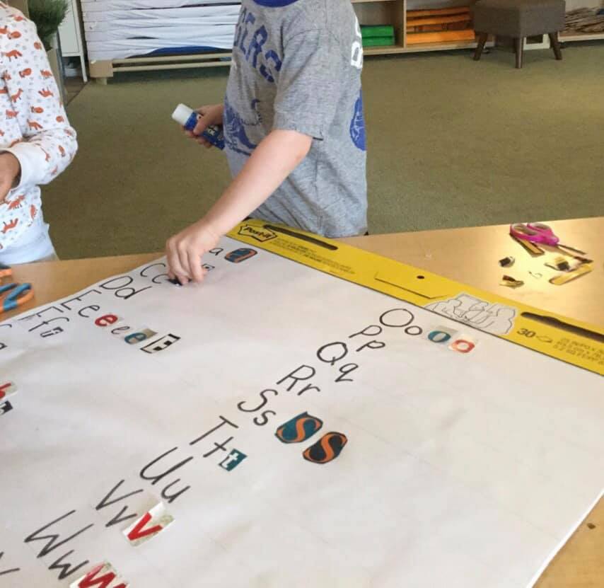 A boy in a gray shirt with the word ers on it