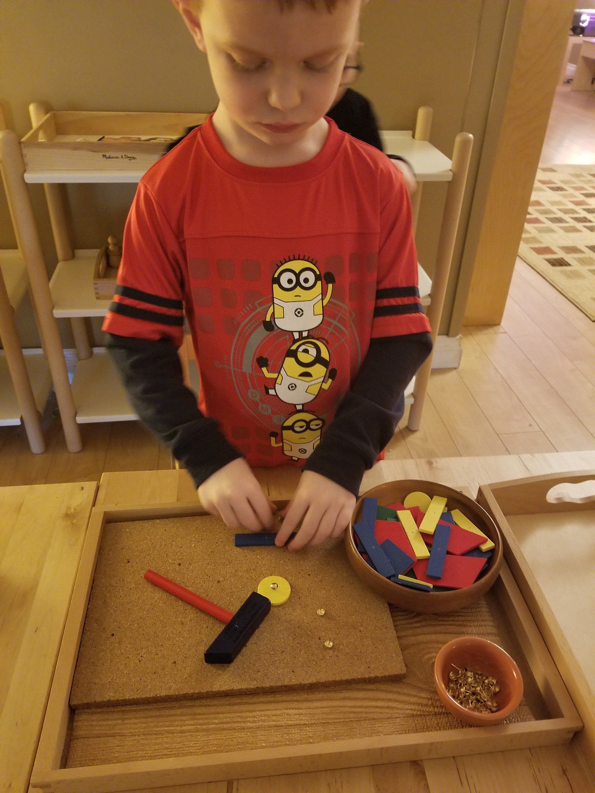 A young boy wearing a red shirt with minions on it