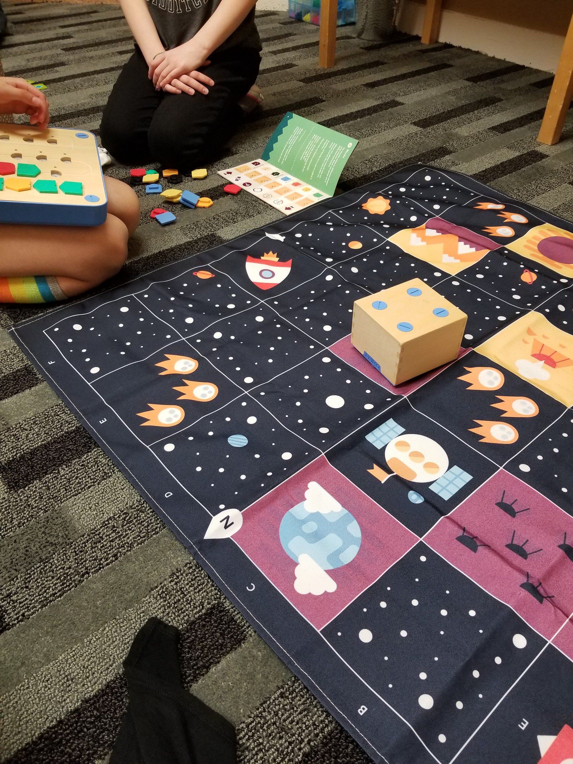 A person is kneeling on the floor playing a game