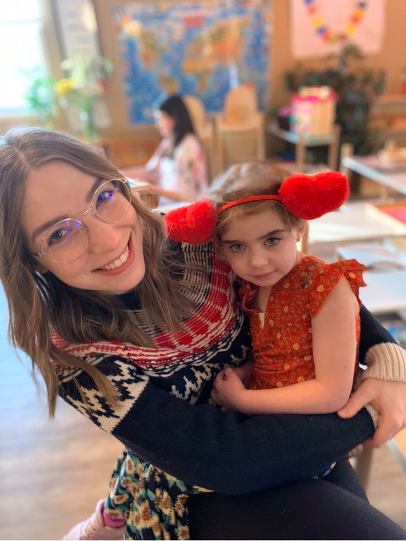 A woman is holding a little girl in her arms.