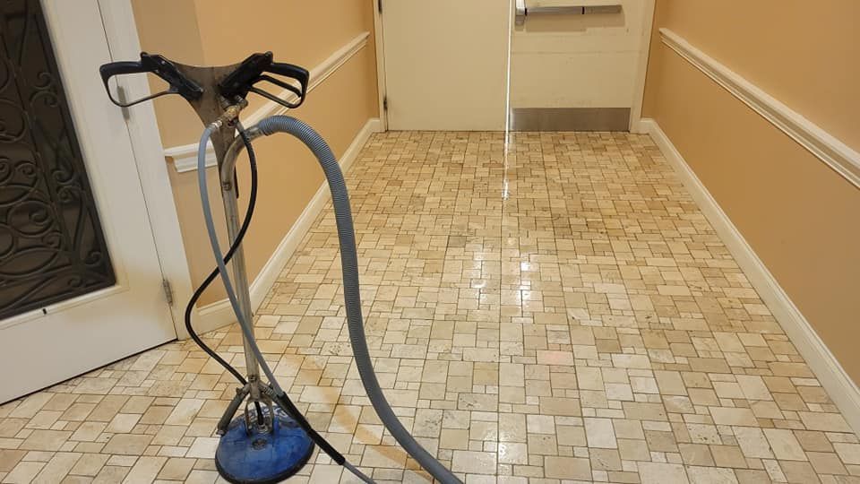 Yellow house with white garage door and walkway, palm trees in front yard.