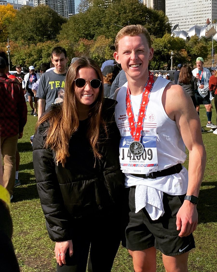 A Man And A Woman Are Posing For A Picture At A Marathon - Chicago, IL - Fast Track Physio