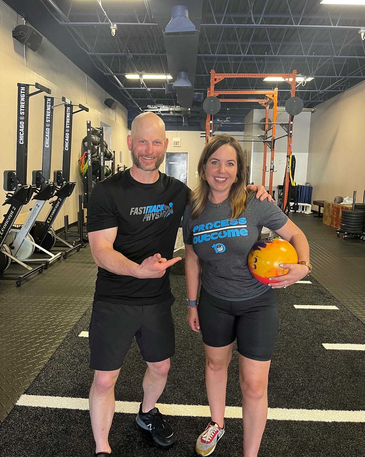 A Man Stands Next To A Woman - Chicago, IL - Fast Track Physio