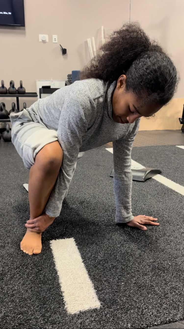 A Woman Is Squatting On The Floor - Chicago, IL - Fast Track Physio
