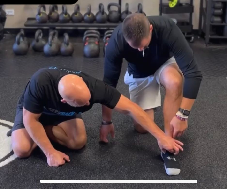 A Bald Guy Checking Guy's Feet - Chicago, IL - Fast Track Physio