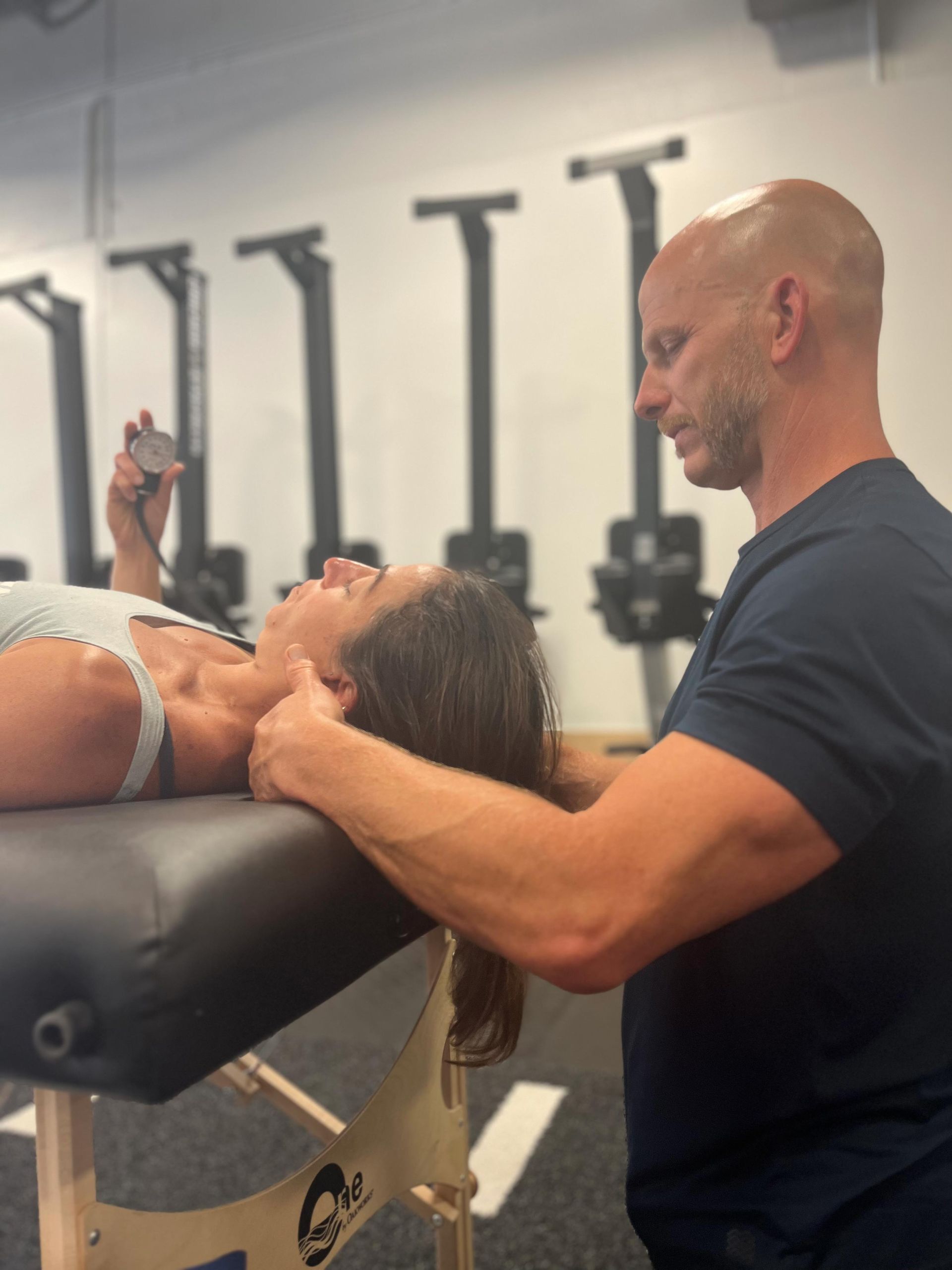 A Woman Holding A Device And A Man - Chicago, IL - Fast Track Physio