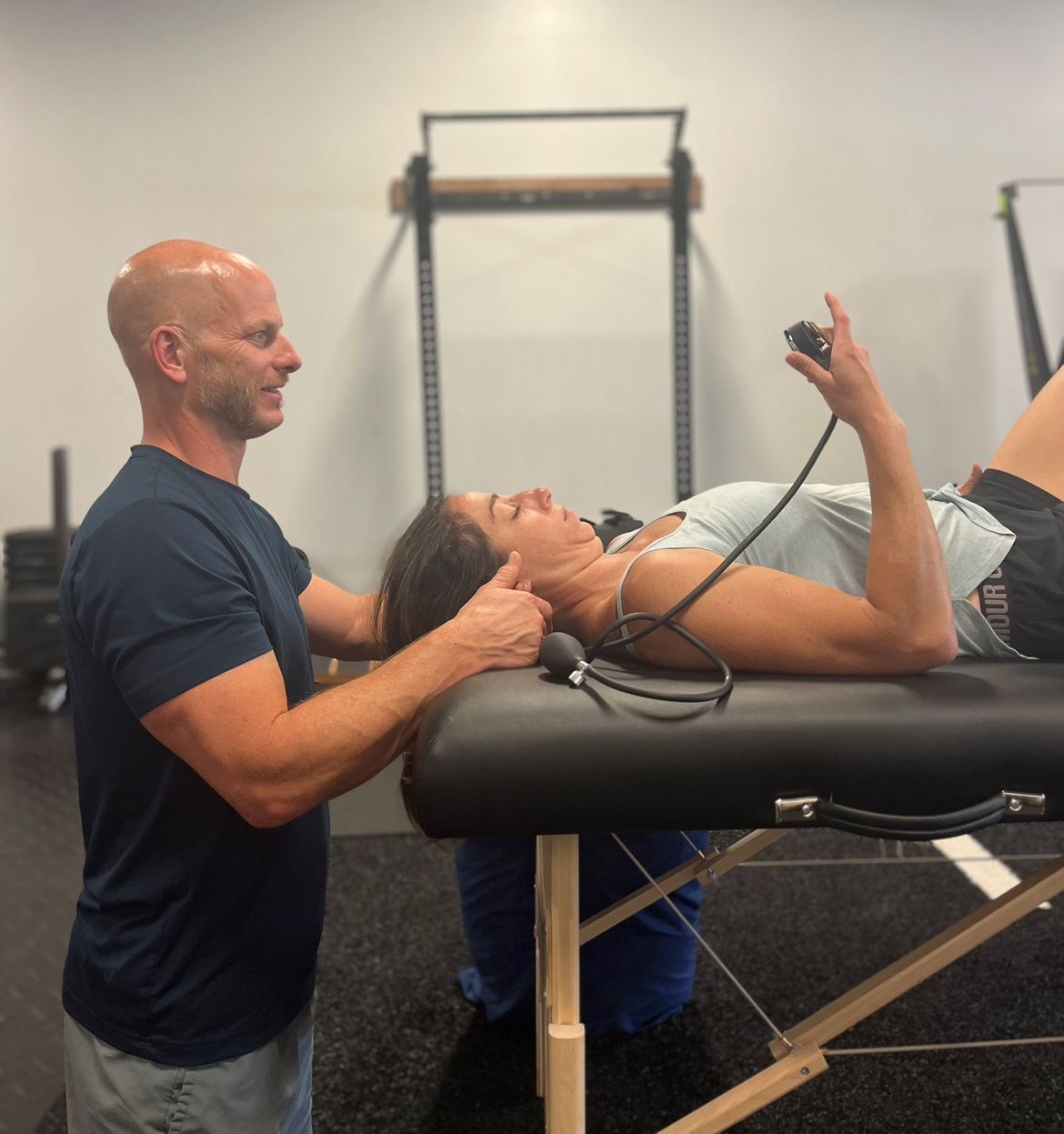 A Bald Guy And A Woman Lying On A Table - Chicago, IL - Fast Track Physio