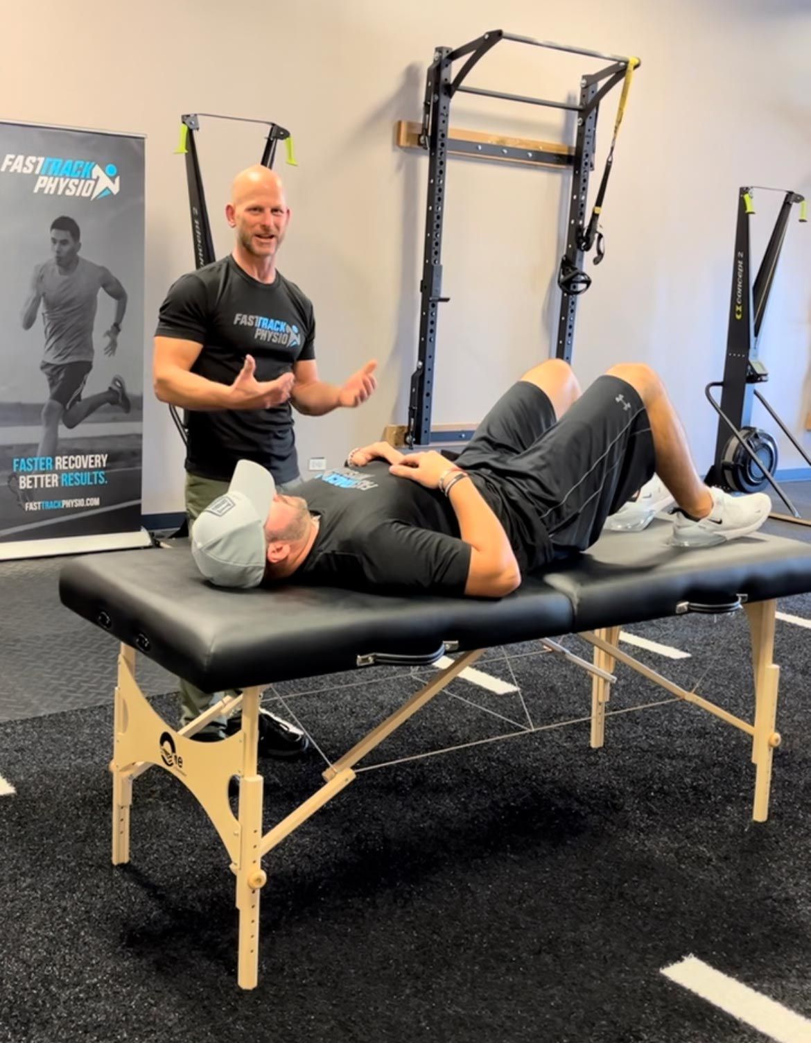 A Man With A Cap And A Bald Guy - Chicago, IL - Fast Track Physio