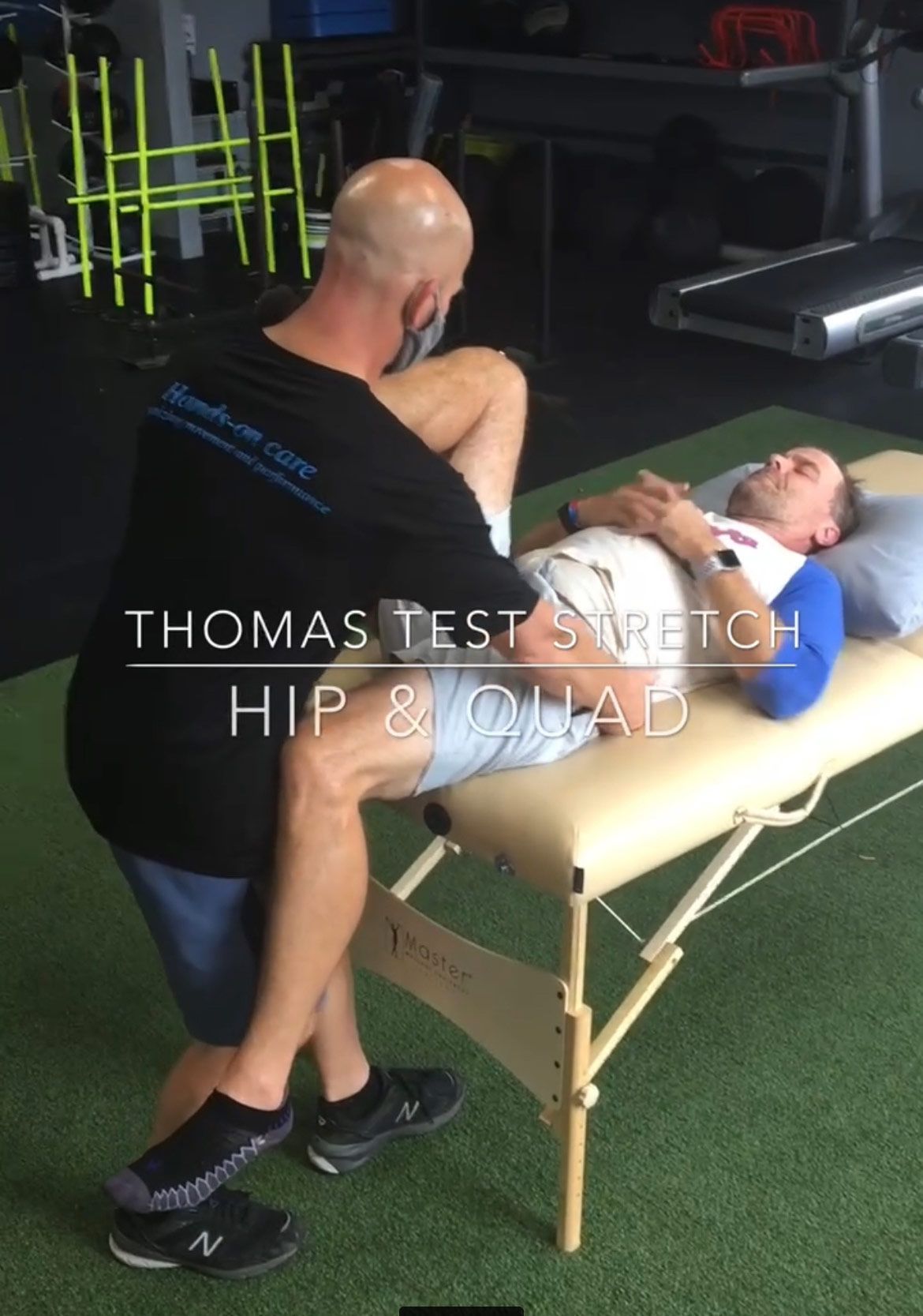 A Man Is Stretching Another Man 's Leg On A Table - Chicago, IL - Fast Track Physio