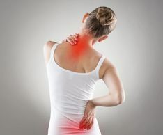 The Woman Is Holding Her Neck And Back In Pain - Chicago, IL - Fast Track Physio