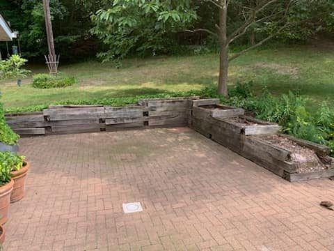 Exterior of a brick building with a bench in front. The building has large windows and a statue.