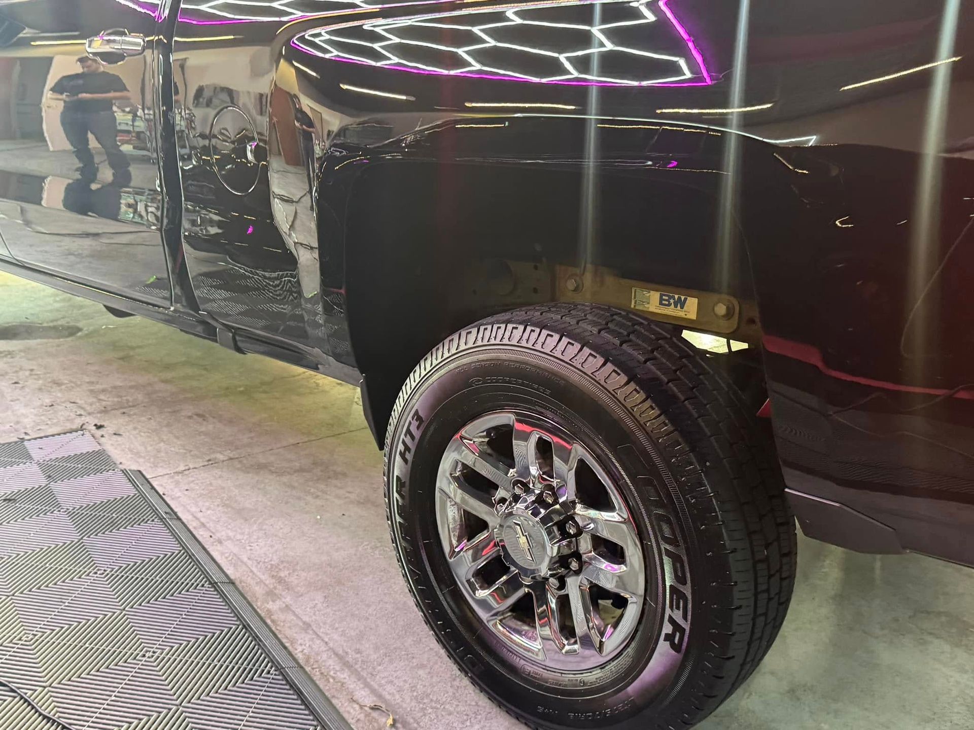 Black pickup truck with a shiny chrome wheel.