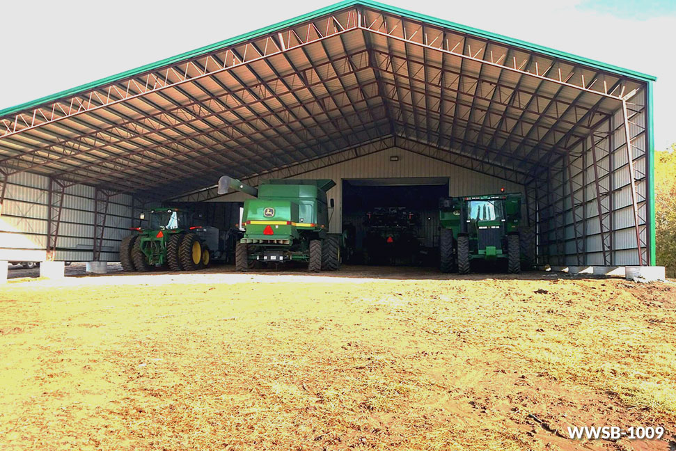 two john deere tractors are parked inside of a shed