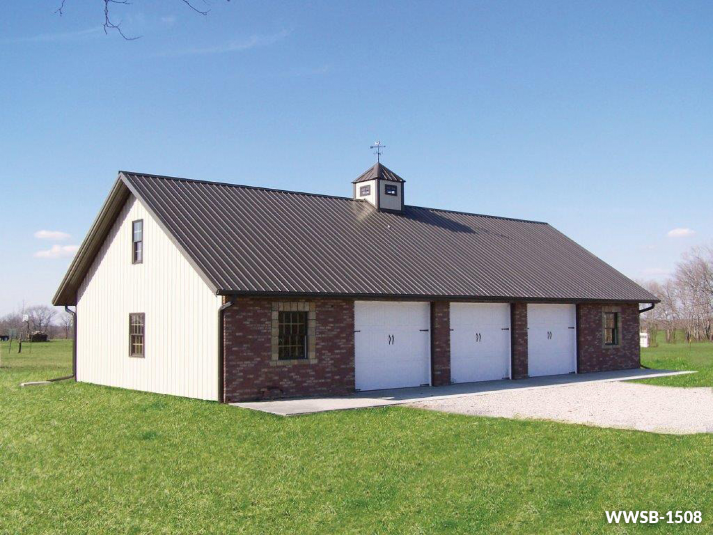 a large barn with a brown roof and white doors