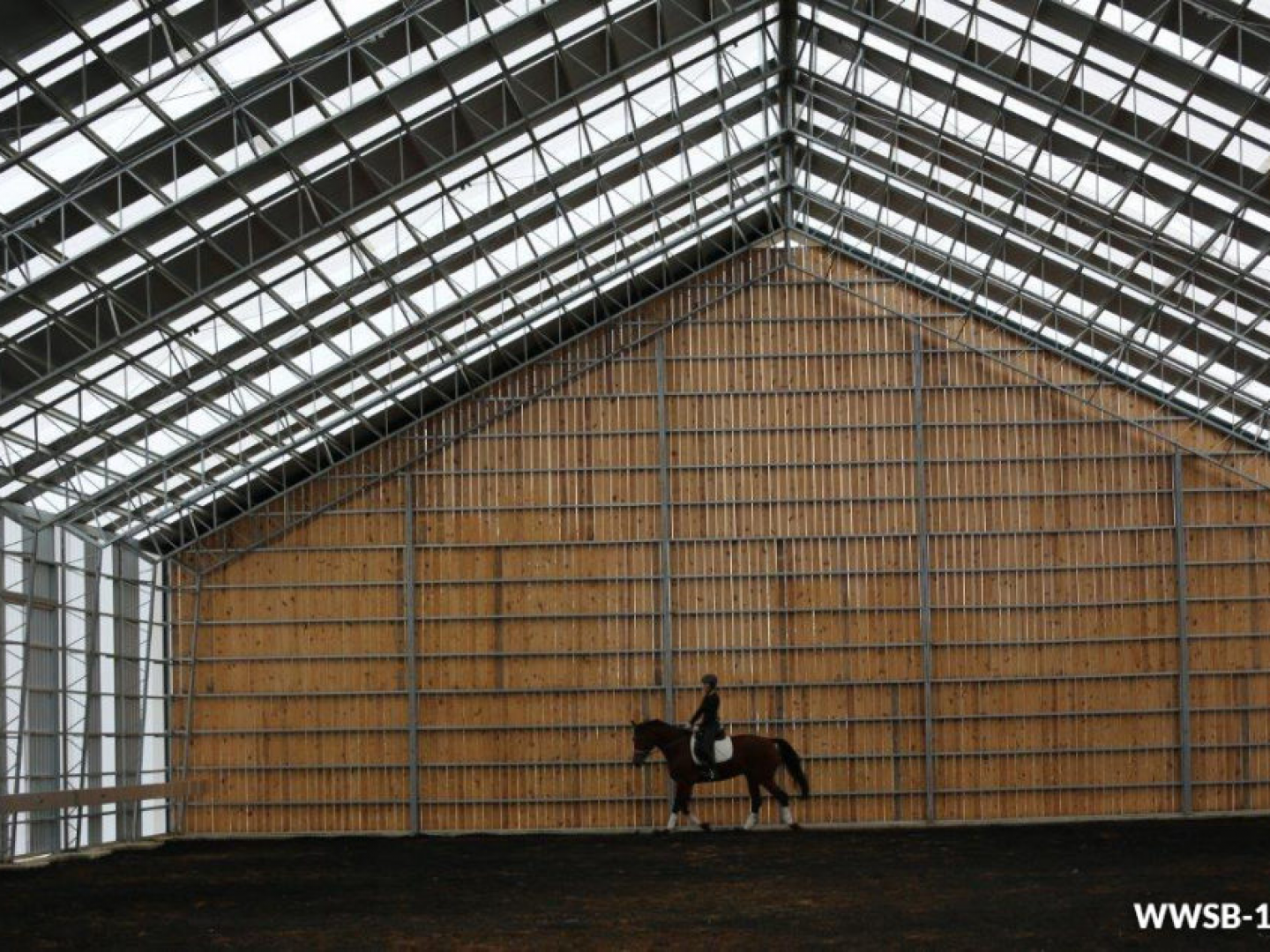 a person is riding a horse inside of a building