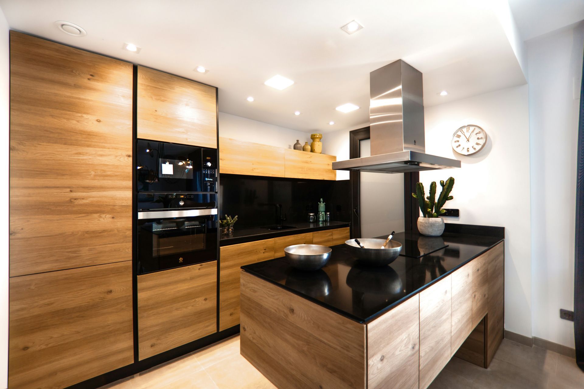 A kitchen with wooden cabinets and a black counter top.