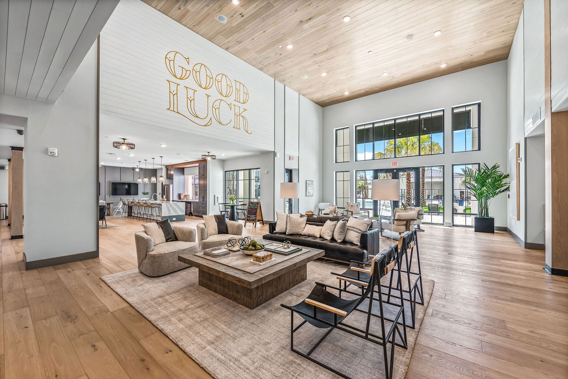 A living room filled with furniture and a sign that says good luck at Livano Nature Coast.