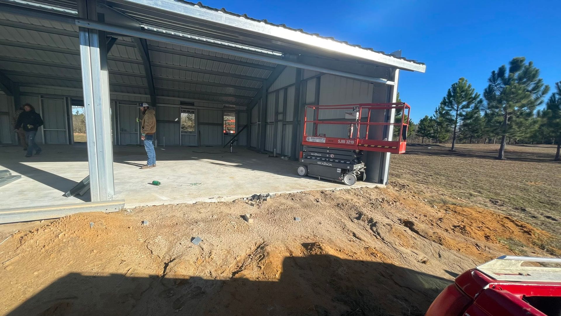 Construction site: metal building partially constructed