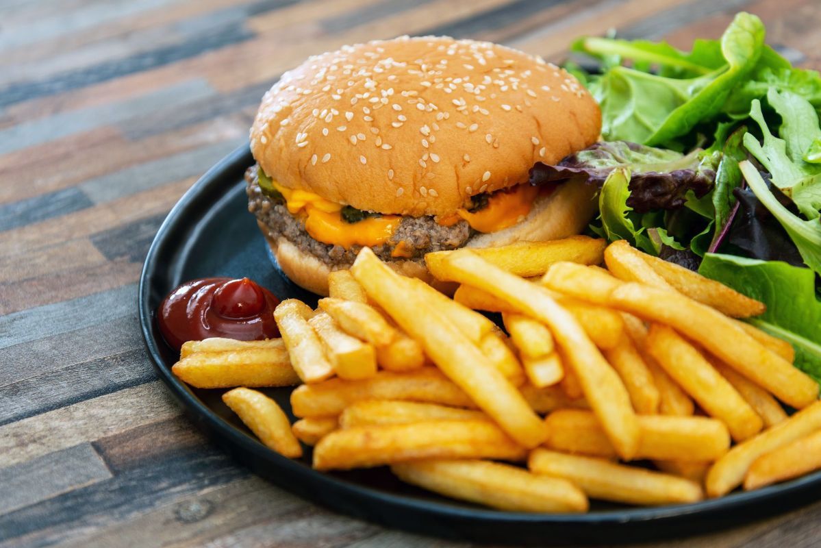 There is a hamburger and french fries on a plate.