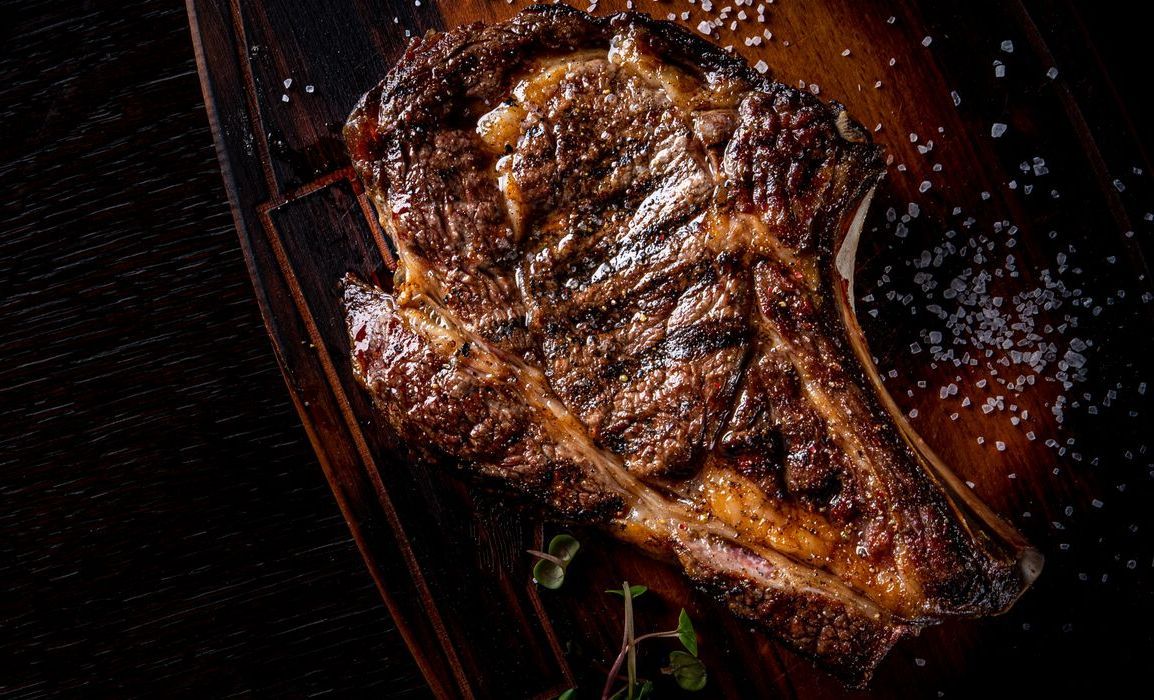 A sunset over a mountain range with a lot of fog