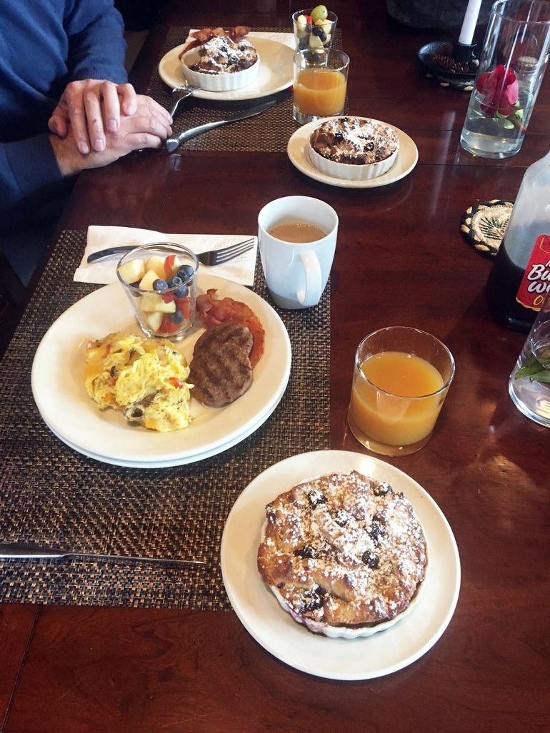 A table topped with plates of food.