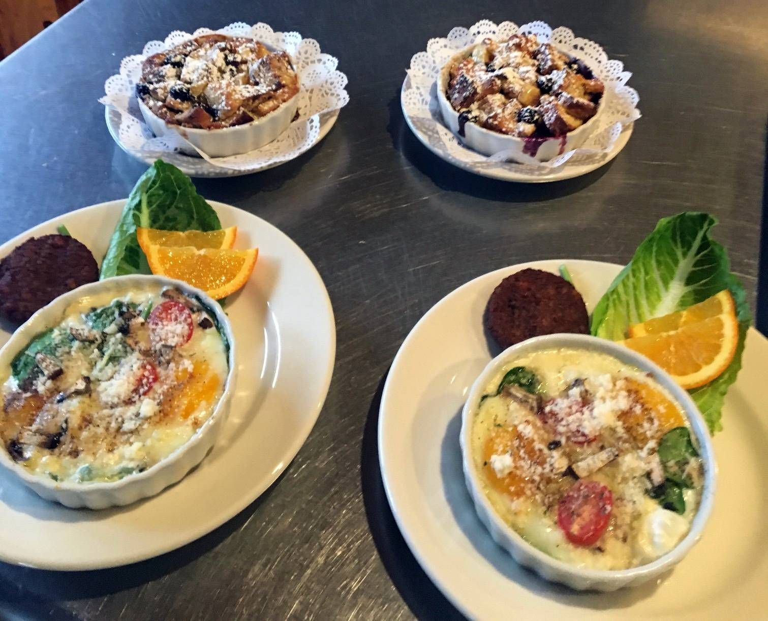 A table with four plates of food on it
